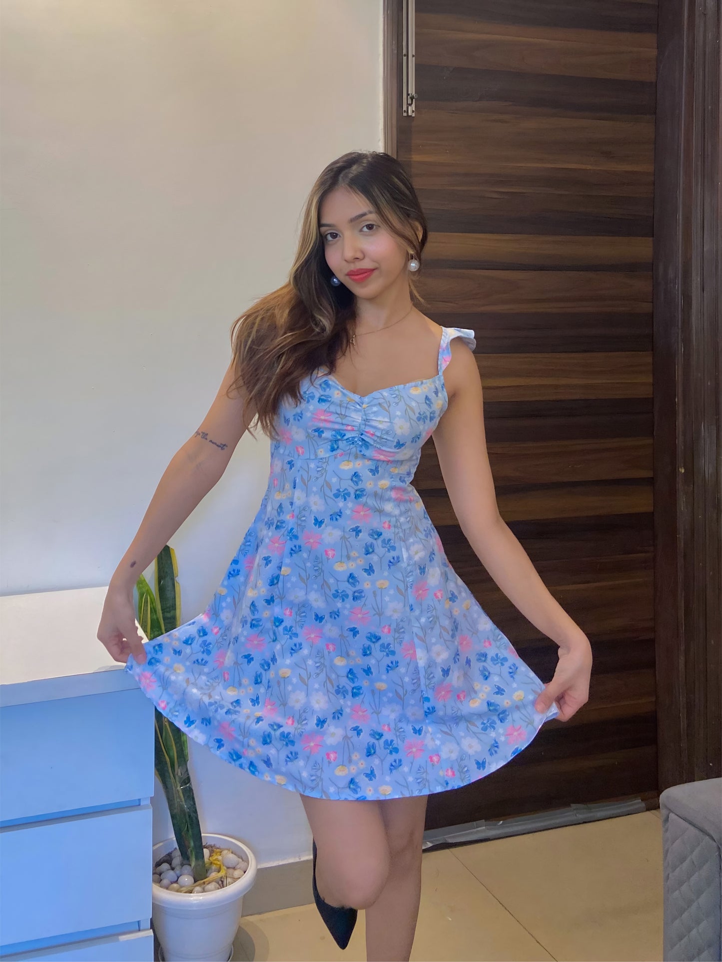 A short blue Summer floral dress, a front pose.